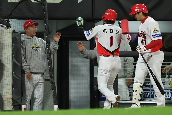 <yonhap photo-6030="">23일 광주 기아챔피언스필드에서 열린 2024 신한 SOL뱅크 KBO 포스트시즌 한국시리즈 2차전 삼성 라이온즈와 KIA 타이거즈의 경기. 1회말 무사 1,2루 KIA 김도영 희생타 때 홈을 밟은 박찬호가 이범호 감독과 하이파이브를 하고 있다. [연합뉴스]</yonhap>