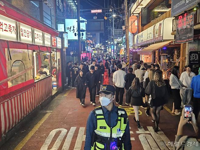 핼러윈데이를 닷새 앞둔 26일 저녁 9시 시민들이 도로에 설치된 좌우 통행로에 양쪽으로 안전하게 이동하고 있다. 이용경 기자