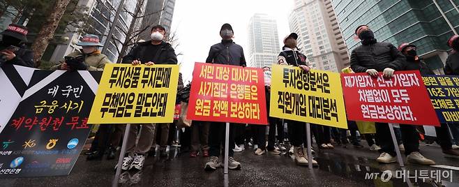 [서울=뉴시스] 김선웅 기자 = 홍콩ELS피해자들이 29일 서울 여의도의 한 은행 앞에서 집회를 열고 금융상품 손실 보상을 촉구하고 있다. 2024.03.29. mangusta@newsis.com /사진=김선웅