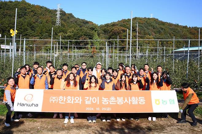 한화 임직원이 지난 25일 경기 포천시 영중면 사과 농가에서 작업을 돕는 모습. [한화 제공]