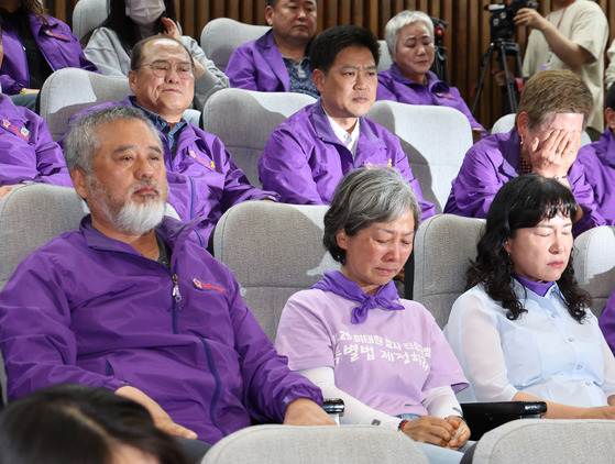 Relatives of victims who perished in the Itaewon crowd crush of Oct. 29, 2022, begin to cry in the National Assembly in Yeouido, western Seoul, after the legislature passed a bill mandating a new investigation into the disaster on May 2. [NEWS1]