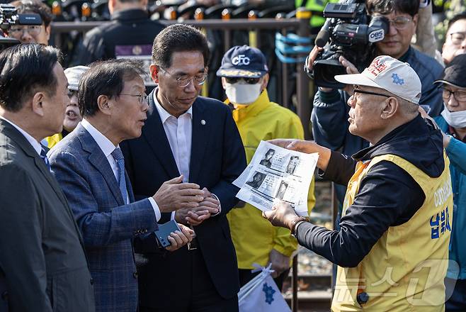 최성룡 납북자피해가족연합회 대표가 31일 오전 경기도 파주시 임진각 내 6·25전쟁납북자기념관 앞에서 대북 전단 살포를 시도하던 중 김경일 파주시장을 비롯한 민주당 의원들과 대화하고 있다. 2024.10.31/뉴스1 ⓒ News1 이재명 기자