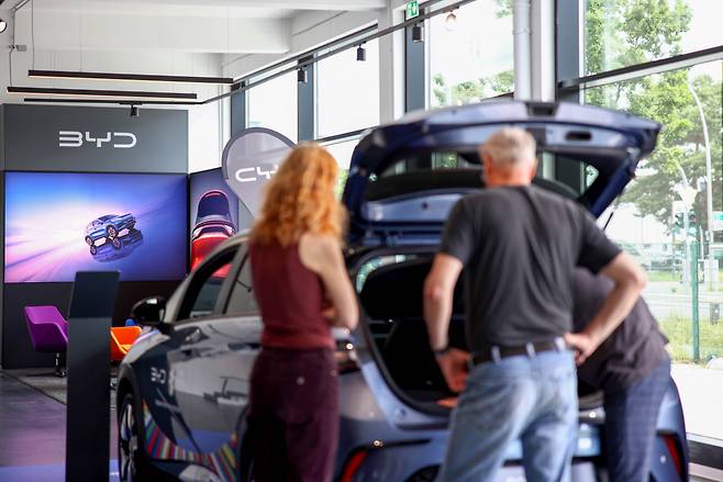 Customers browse electric vehicles at a BYD showroom in Berlin. (Bloomberg)