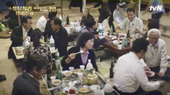 A funeral scene featured in the TV drama “Reply 1988″ shows a festive mood with all the attendees eating and drinking together with the bereaved family. [SCREEN CAPTURE]