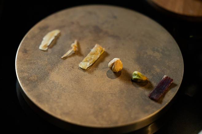 A selection of small bites at Yun Seoul, featuring scallop, cuttlefish, shrimp, hazelnut, pistachio, and beef jerky (from left). Dried seafood and jerky are often used in broths or sauces. /Yun Seoul