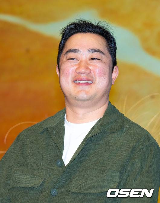 [OSEN=민경훈 기자] 16일 오후 서울 구로구  신도림 디큐브시티 더 세인트에서 지니 TV 오리지널 드라마 '나미브' 제작발표회가 열렸다. 이 드라마는 해고된 스타 제작자 강수현(고현정 분)과 방출된 장기 연습생 유진우(려운 분)가 만나 각자의 목표를 위해 나아가는 이야기를 담은 드라마. 한편 배우 고현정은 갑작스러운 건강 악화로 제작발표회에 불참했다.강민구 감독이 미소짓고 있다. 2024.12.16 / rumi@osen.co.kr