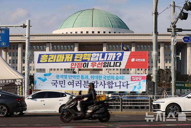 [서울=뉴시스] 권창회 기자 = 25일 서울 여의도 국회 앞에 각 당이 내건 현수막이 걸려있다. 더불어민주당은 지난 24일 한덕수 대통령 권한대행의 탄핵소추안을 당론 채택했으나 국회 추천 몫 헌법재판관 3명의 임명 여부를 지켜보겠다며 당초 계획을 보류했다. 2024.12.26. kch0523@newsis.com