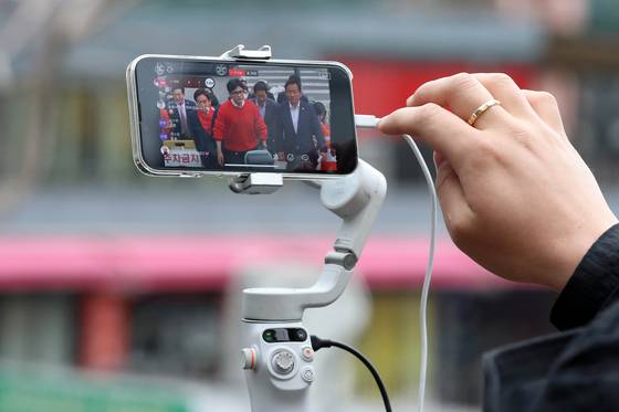 A YouTuber is livestreaming conservative People Power Party leader Han Dong-hoon entering a voting booth for the parliamentary elections on April 10, 2024, in Seodaemun District, western Seoul. [NEWS1]