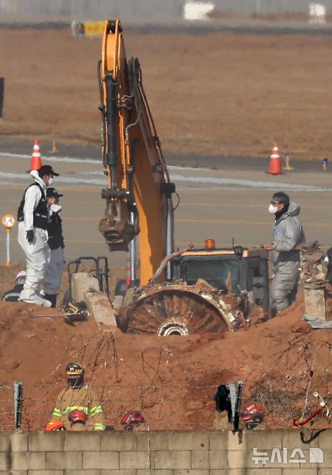 [무안=뉴시스] 김선웅 기자 = 2일 전남 무안국제공항 제주항공 여객기 참사 현장에서 로컬라이저(방위각 표시 시설)가 설치된 콘크리트 둔덕에 파묻혀 있던 엔진이 모습을 드러내고 있다.  2025.01.02. mangusta@newsis.com