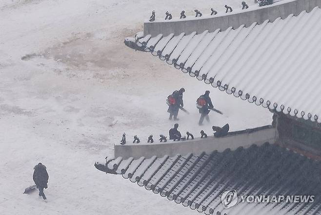 서울 등 수도권에 대설특보가 내려진 5일 서울 종로구 경복궁에서 작업자들이 눈을 치우고 있다. ⓒ연합뉴스