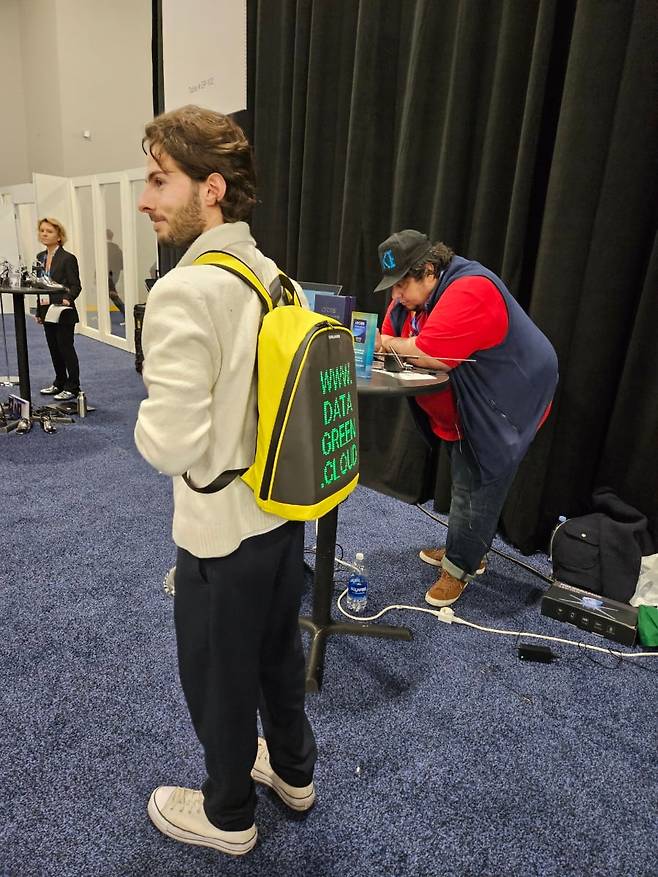 5일 미국 라스베이거스 만델레이 호텔에서 열린 CES 2025 ‘언베일드(Unveiled)’ 행사에서 프랑스 스타트업 ‘데이터 그린’ 관계자가 백팩을 메고 서 있다. 중형 데이터 센터를 가방 크기까지 줄일 수 있다는 점을 강조하기 위한 퍼포먼스다. /라스베이거스=박지민 기자