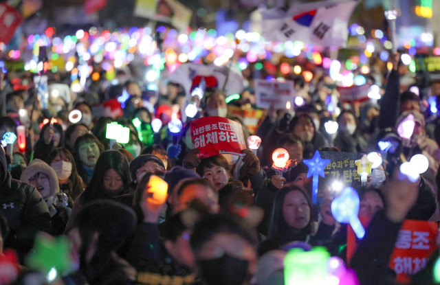 ▲12일 오후 서울 영등포구 국회 앞에서 열린 윤석열 대통령 탄핵 촉구 촛불 집회에 참석한 시민들이 응원봉을 흔들며 구호를 외치고 있다. ⓒ연합뉴스