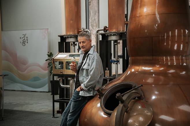Andrew Shand poses for a photo, holding a glass of whisky. (Ki One Whisky Distillery)