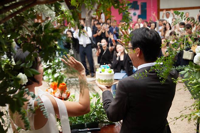 2023년 9월17일 열린 이길보라와 다나카 겐의 교차문화결혼식. 손을 들어 인사를 전하는 두 사람에게 하객들이 두 팔을 들어 박수갈채를 보내고 있다. 사진 성재윤