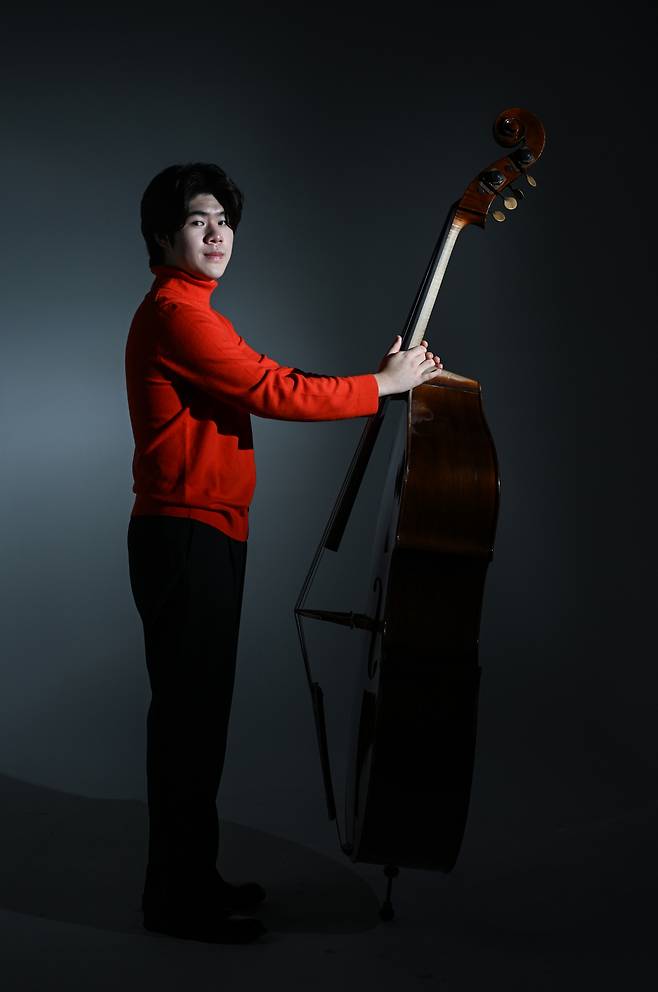 Double bassist Ryu Si-heon poses for photos during an interview with The Korea Herald on Dec. 26, 2024. (Lee Sang-sub/The Korea Herald)