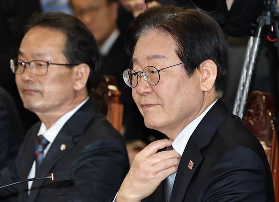 이재명 더불어민주당 대표가 지난 20일 오후 서울 중구 명동 은행연합회관에서 열린 '민생 경제 회복을 위한 더불어민주당-은행권 현장간담회'에서 모두발언 전 넥타이를 매만지고 있다. 뉴스1