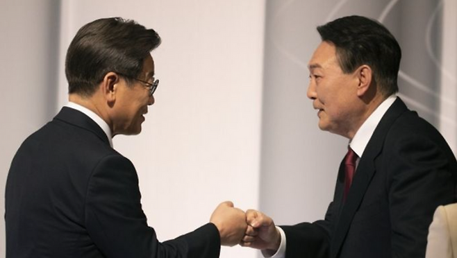 2022년 2월 25일 당시 더불어민주당 이재명 대선 후보(왼쪽)와 국민의힘 윤석열 대선후보가 서울 마포구 상암동에서 열린 중앙선거관리위원회 주관 제20대 대통령선거 후보자 2차 정치분야 방송토론회에서 주먹인사하고 있다. ⓒ국회사진기자단