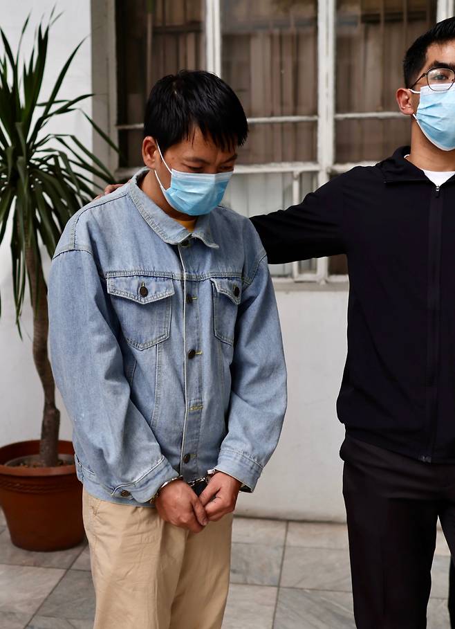 필리핀 군사기지와 발전소 등을 정찰하고 3차원 영상 자료를 작성한 혐의를 받는 중국인 덩위안칭이 1월20일 필리핀 법무부에서 경찰에 호송되는 모습. /EPA 연합뉴스