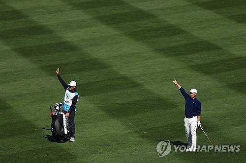 볼이 빗나가자 관중에게 경고하는 김주형과 캐디. [AFP/게티이미지=연합뉴스]