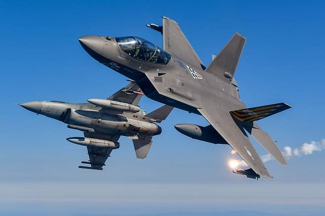 South Korea's homegrown supersonic fighter jet KF-21 (right) launches a flare during a test flight alongside a KF-16, Wednesday. (South Korean Air Force)