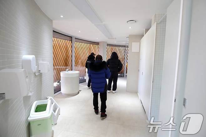 대구 수성구 수성못 상화동산 공중화장실이 최근 리모델링 공사를 마치고 개방됐다. 스페인 건축가의 설계를 바탕으로 예술적 요소를 강조한 이 화장실 리모델링 공사에 수성구가 예산 9억 원을 투입한 사실이 알려지며 논란이 일고 있다. 20일 수성못을 찾은 시민들이 공중화장실 내부를 살펴보고 있다. 2025.2.20/뉴스1 ⓒ News1 공정식 기자