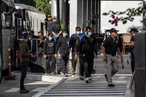 People deported from the U.S., including some from Asian, Middle Eastern and African countries, are taken to the Decapolis Hotel in Panama City on Feb. 15, 2025. Nearly 100 migrants who had been detained here were loaded onto buses on Feb. 18 and moved to a primitive detention camp in the Darién Gap jungle, several of the migrants said. (Federico Rios Escobar/The New York Times)