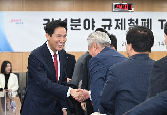 오세훈 서울시장이 25일 서울시청에서 열린 '건설 분야 규제철폐 TF 성과보고회'에 참석해 건설 분야 관계자와 인사를 나누고 있다. [사진=서울시]