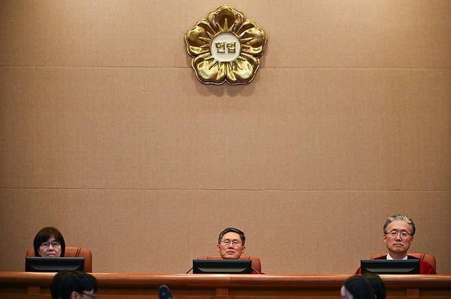 Constitutional Court of Korea justices (from left) Lee Mi-son, acting Chief Justice Moon Hyung-bae and Kim Hyung-du are seen during the 11th and final hearing of President Yoon Suk Yeol's impeachment trial, Tuesday. (Yonhap)