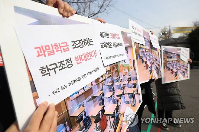 2021년 '과밀학급 조장하는 학구조정 반대' 시위 (서울=연합뉴스) 강민지 기자 = 2021년 11월23일 서울 종로구 서울시교육청 앞에서 위례 학교 과밀방지를 위한 학부모 연합회가 개최한 '서울시 교육청의 과밀학급 문제 해결 촉구! 강동송파교육지원청의 행정절차 무시한 행정예고 규탄!' 기자회견에서 참석자들이 퍼포먼스를 하고 있다. [연합뉴스 자료사진]