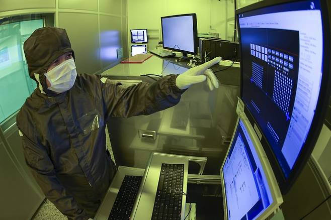 방진복을 착용한 이혁재 서울대 반도체공동연구소장이 서울 관악구 서울대학교 반도체공동연구소에서 마스크리스 리소그래피 시스템 포토 장비를 설명하고 있다. 이 장비를 사용할 경우 포토마스크를 사용하지 않고 원하는 패턴을 파일 형태에서 직접 웨이퍼 위로 그릴 수 있다. / 사진=임형택 기자
