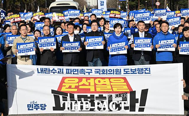 박찬대 더불어민주당 원내대표를 비롯한 민주당 의원들이 13일 오후 서울 여의도 국회에서 '내란 수괴 윤석열 파면을 촉구'하는 도보행진에 앞서 피켓을 들고 구호를 외치고 있다. /국회=박헌우 기자