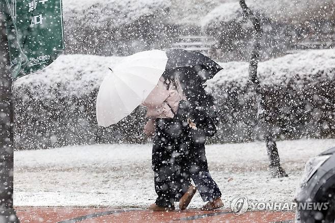 우산으로 막는 춘삼월 눈보라 (광주=연합뉴스) 김혜인 기자 = 춘삼월 눈이 내린 18일 오전 광주 북구 용봉동 전남대학교에서 학생들이 우산을 쓴 채 교정을 걷고 있다. 2025.3.18 in@yna.co.kr