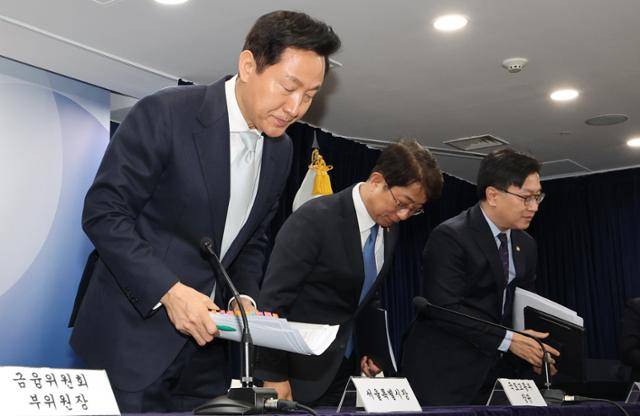 오세훈(왼쪽) 서울시장과 박상우(가운데) 국토교통부 장관이 19일 서울 종로구 정부서울청사에서 주택시장 안정화 방안 브리핑을 마치고 고개 숙여 인사하고 있다. 뉴스1