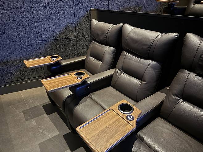 Recliner seats, featuring mini table trays, at the four-screen ScreenX at CGV Yongsan in central Seoul [KIM JI-YE]