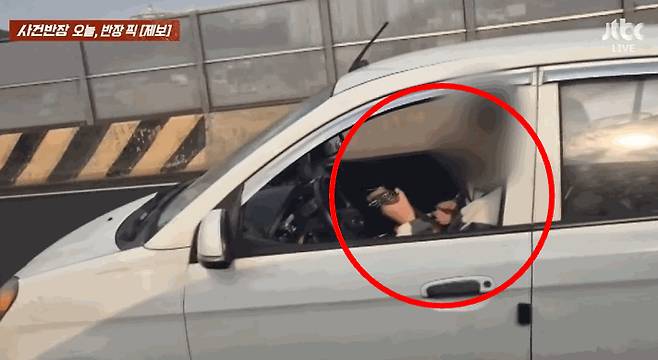 서울 내부순환도로를 달리는 차 안에서 기타를 치고 있는 운전자 모습. /사진=JTBC 사건반장 갈무리