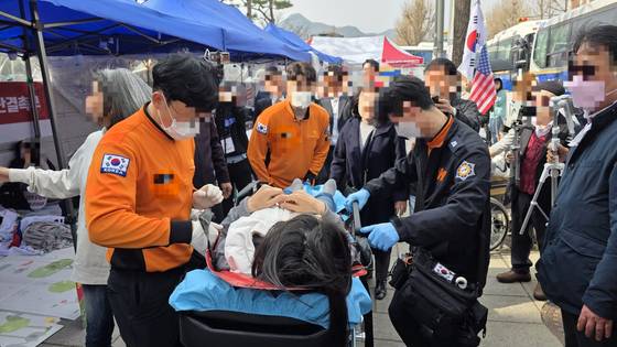 24일 오후 3시쯤 헌법재판소 정문 앞에서 윤석열 대통령 탄핵 반대 단식농성을 벌이던 윤모씨가 건강 이상 증세로 병원에 후송되고 있다. 김창용 기자