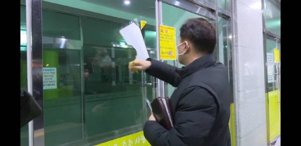 2021년 1월 19일 오전 부산 강서구 세계로교회에서 손현보 담임목사가 강서구가 붙인 시설폐쇄 고지문을 떼어내고 있다. 국제신문 DB