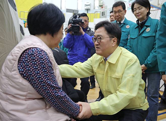 우원식 국회의장이 28일 경북 의성군 의성읍 의성체육관에 마련된 산불 대피소를 찾아 이재민을 위로하고 있다.
