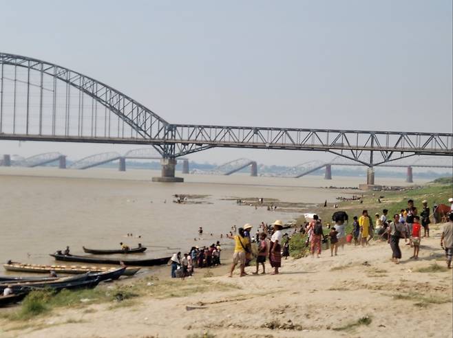 미얀마 강진 31일 미얀마 만달레이에서 주민들이 목선을 이용해 에야와디강을 건너 사가잉 지역으로 가려는 모습. 멀리 지진으로 무너진 철교가 보인다. [미얀마 교민 제공. 재판매 및 DB 금지]