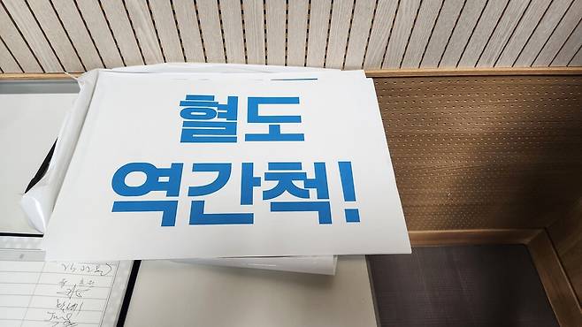 전남 해남 '혈도 역간척(逆干拓)' 어떻게 해야 할까. 해남 문내면과 황산면 일원에 위치한 혈도 연안 복원을 위한 토론회가 3월 31일 오후 군의회에서 열렸다. 태양광사업이라는 현실적 벽을 뚫고 간척한 지 50년이 훌쩍 넘은 혈도를 갯벌로 되돌릴 수 있을까. 서명부 위에 놓인 '역간척' 피켓 ⓒ시사저널 정성환