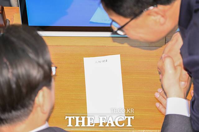 이재명 더불어민주당 대표가 4일 오후 서울 여의도 국회에서 열린 본회의에 참석해 김우영 의원으로부터 '人秘親展(인비친전·인사와 관련한 비밀사항에 대해 해당자에게만 밀봉해 전하는 형식)'이 적힌 봉투를 건네받고 있다. /국회=박헌우 기자