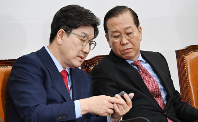 권영세(오른쪽) 국민의힘 비상대책위원장이 4일 국회에서 열린 비상대책위원회의에서 권성동 원내대표과 휴대폰을 보고 있다. 고영권 기자