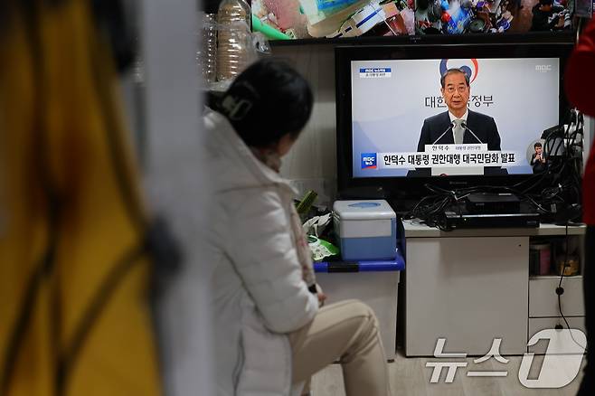4일 오전 서울 시내의 한 전통시장에서 한 시민이 윤석열 대통령의 탄핵심판 선고 결과에 따른 한덕수 권한대행 국무총리의 대국민담화 생중계를 지켜보고 있다. 2025.4.4/뉴스1 ⓒ News1 이동해 기자