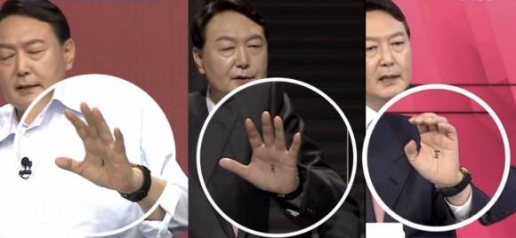 윤석열 전 대통령이 국민의힘 대선 주자 시절 TV토론회 참석 당시 손바닥 한가운데에 왕(王) 자를 그려 놓았던 장면이 카메라에 포착된 모습. 당시 윤 대통령 측은 같은 아파트에 사는 지지자들이 토론이 있을 때마다 응원한다는 뜻으로 적어 준 것이라고 밝혔다. 채널A·MBC·MBN 캡처