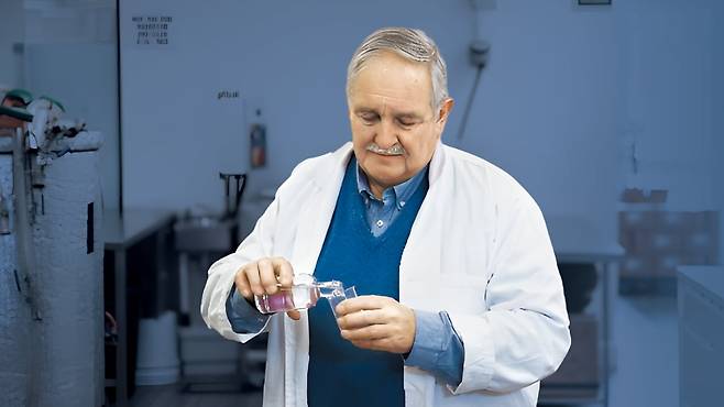 David Nutt, a lifelong alcohol researcher and professor at Imperial College London, pours the key ingredient of his hangover-free alcohol into a cup, in this photo provided by Imperial College London.