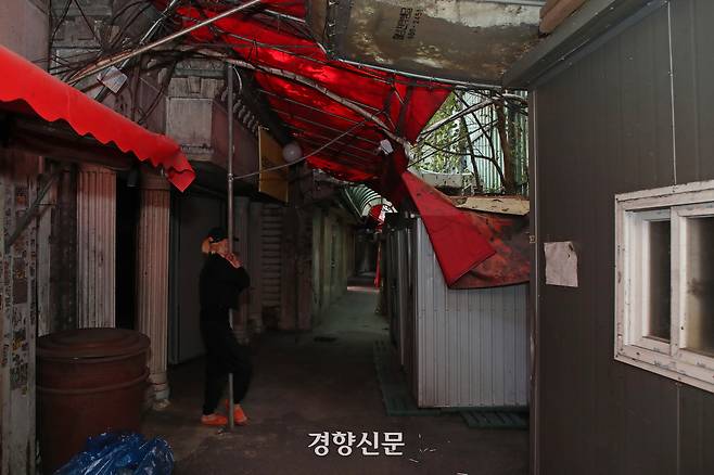 재개발로 인해 철거 예정인 서울시 성북구 미아리 집창촌 내 한 업소 앞에 지난해 10월 한 성매매 여성이 서있다. 이들은 이주 대책 마련을 촉구하는 집회를 여는 등 생존권 투쟁을 하고 있다. 정효진 기자