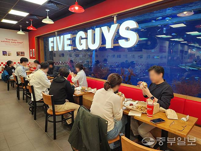 파이브가이즈 광교 내부 한쪽 벽면이 수족관으로 조성돼 있다. 이보현 기자