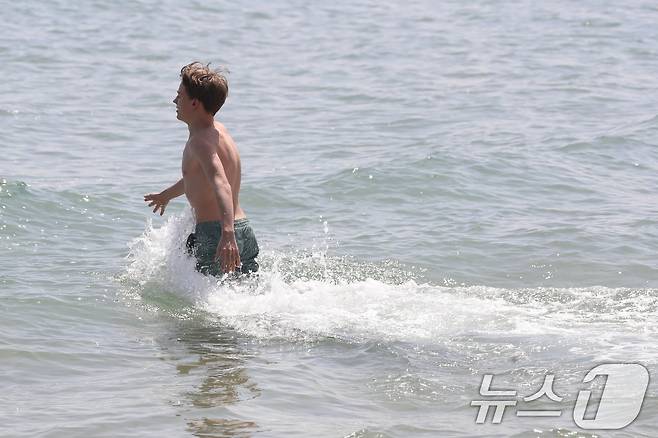 전국적으로 초여름 날씨를 보인 21일 오후 부산 해운대해수욕장을 찾은 외국인이 물놀이를 즐기고 있다. 2025.4.21/뉴스1 ⓒ News1 윤일지 기자