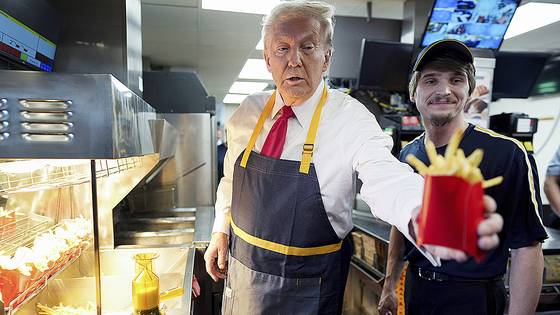 도널드 트럼프 대통령(왼쪽)이 2024년 10월 20일 펜실베이니아에 있는 맥도날드에서 프렌치프라이를 건네고 있다. AP=연합뉴스