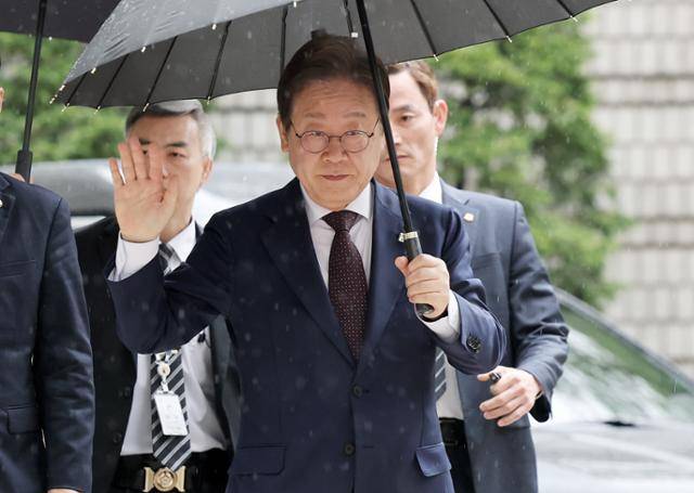 더불어민주당 대선주자 이재명 전 대표가 22일 서울 서초구 서울중앙지법에서 열린 대장동 배임 및 성남FC 뇌물 1심 속행 공판에 출석하며 지지자들에게 인사하고 있다. 뉴스1